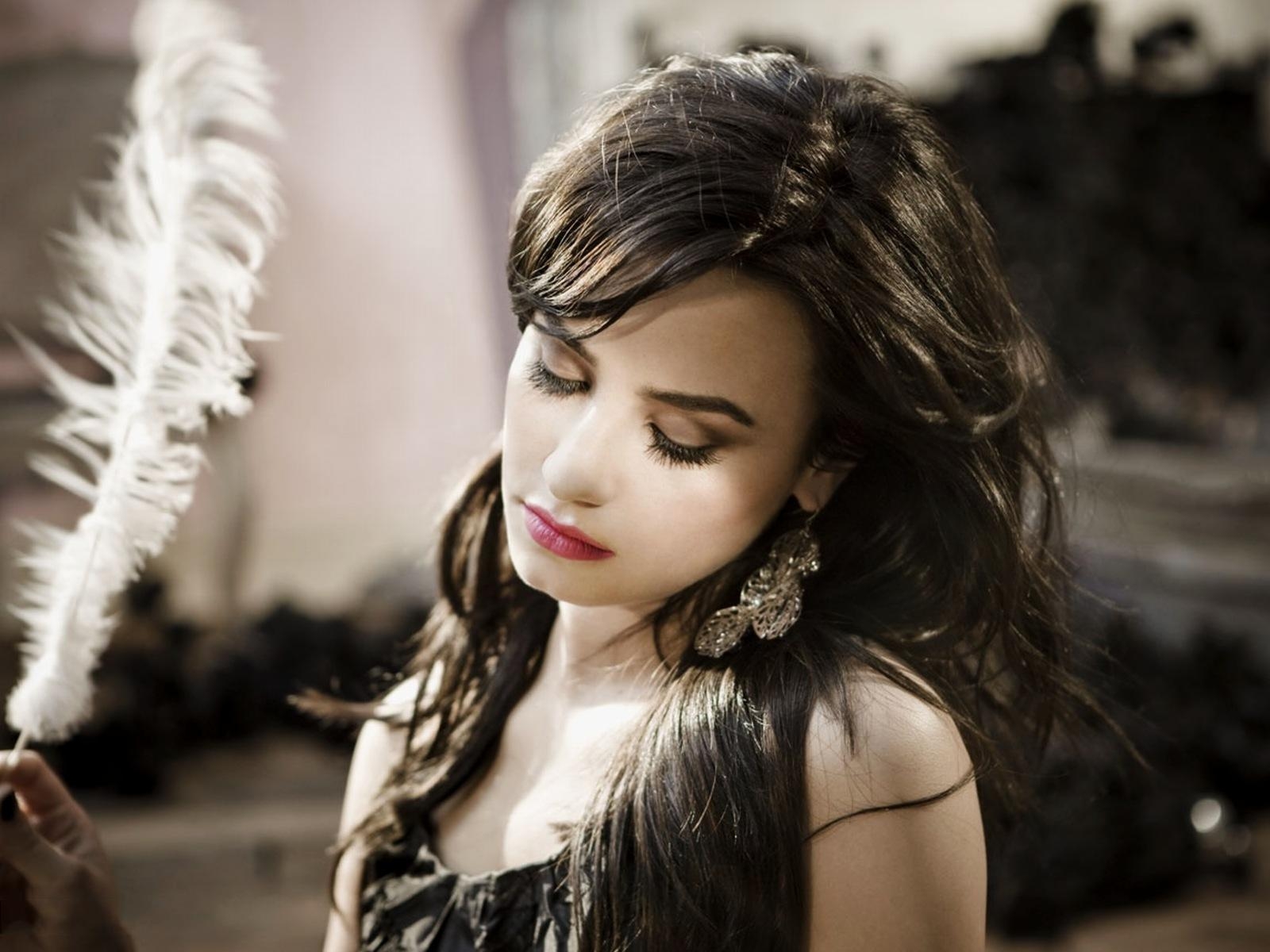 Black Dress Silver Earings Holding Feather